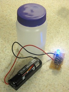 Joule thief next to a small plastic jar