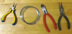 From left to right; roundnose pliers, wire, wire cutters, needlenose pliers