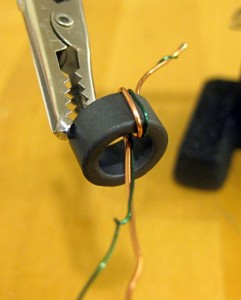 Wrap the wires around the ferrite ring.